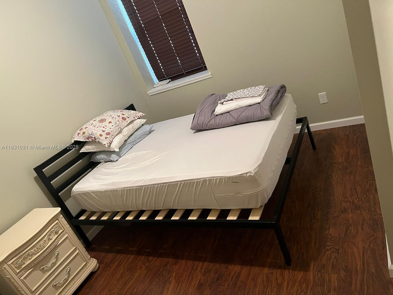 123 Rocky Road Lackawaxen, PA 18435 - Photo 32 of 39 a bed sitting in a bedroom next to a wooden floor