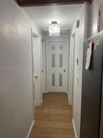 a kitchen with a sink and refrigerator