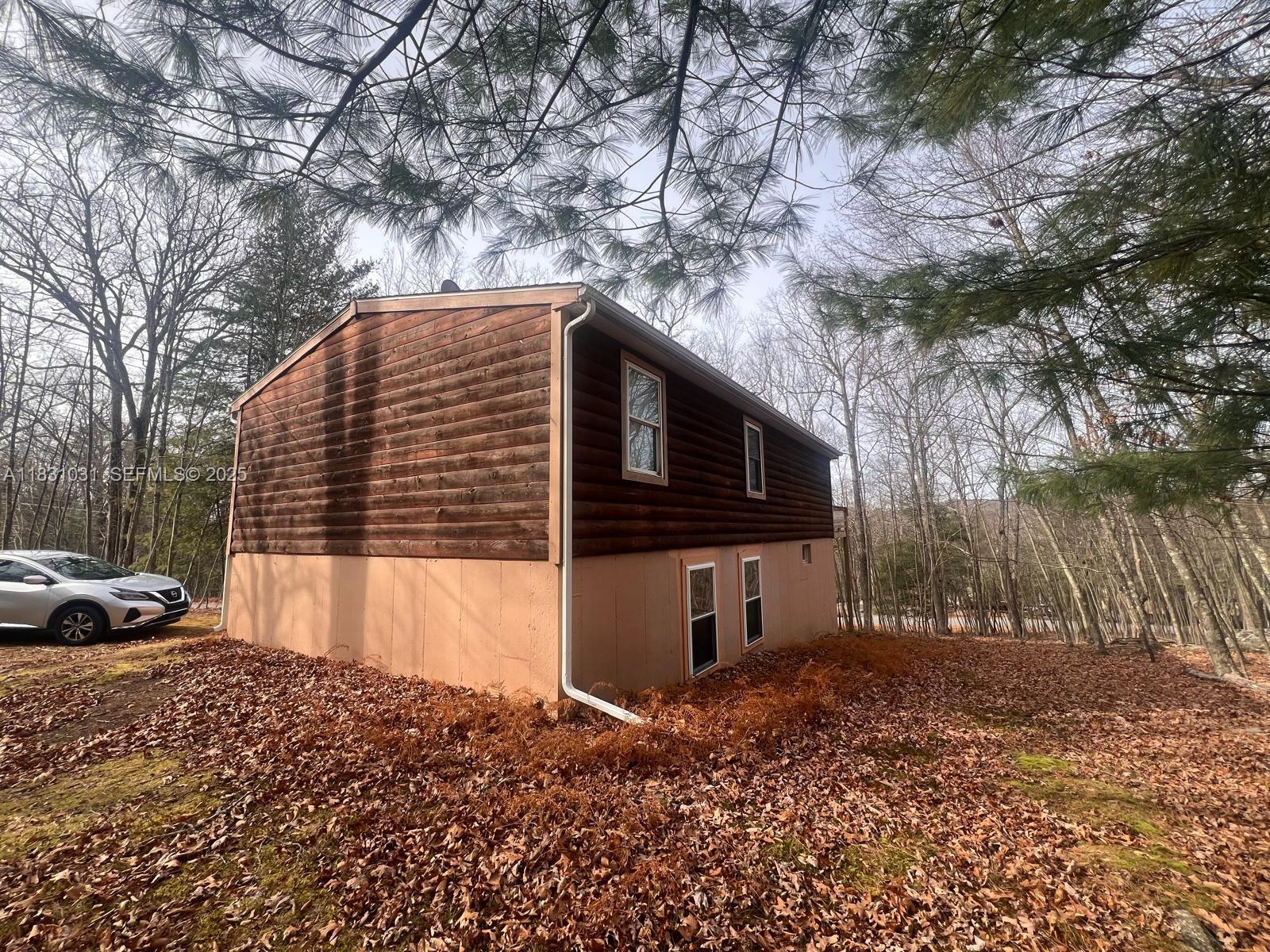 123 Rocky Road Lackawaxen, PA 18435 - Photo 4 of 39 a view of a couches under an umbrella
