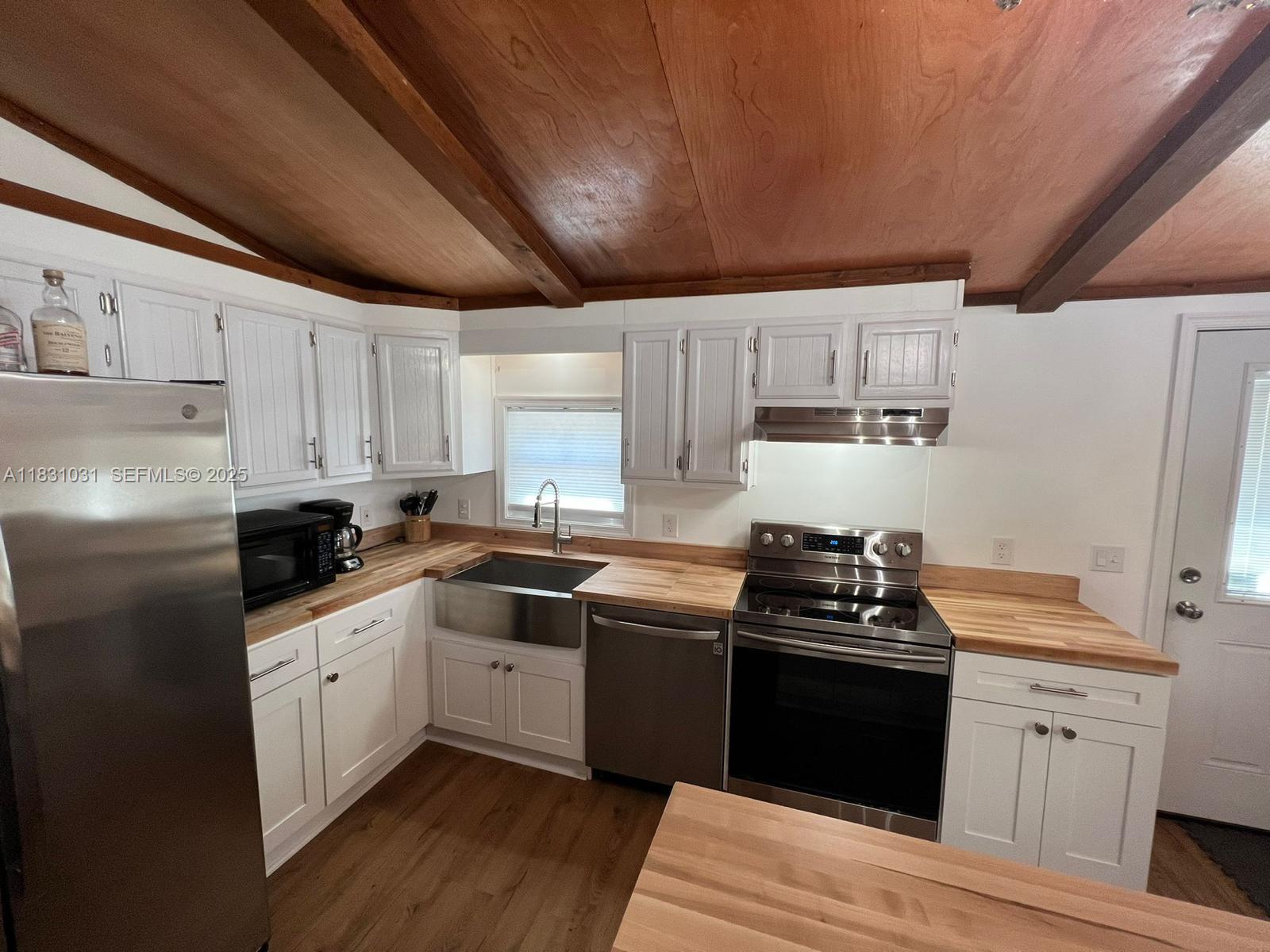 123 Rocky Road Lackawaxen, PA 18435 - Photo 7 of 39 a kitchen with granite countertop a sink stove and refrigerator