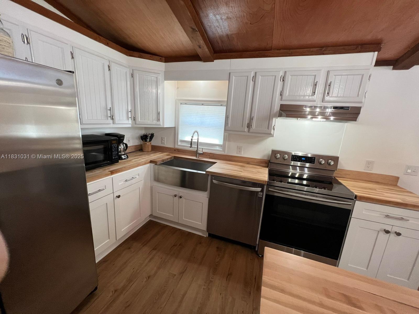 123 Rocky Road Lackawaxen, PA 18435 - Photo 9 of 39 a kitchen with wooden cabinets stainless steel appliances and sink