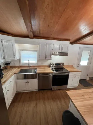 a kitchen with granite countertop a stove and a sink