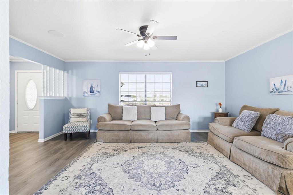 3873 Lois Road East Sanger, TX 76266 - Photo 11 of 40 Living area featuring ornamental molding, wood finished floors, and a ceiling fan