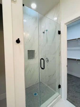 a bathroom with a glass shower door
