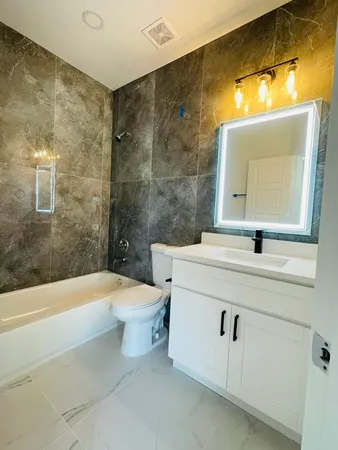 a bathroom with a sink a toilet and bathtub