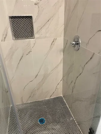 a bathroom with a bathtub and shower