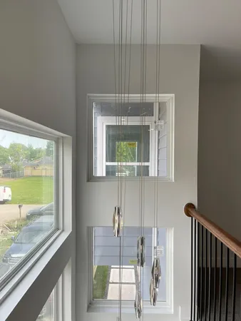 a bathroom with a window a sink and a mirror