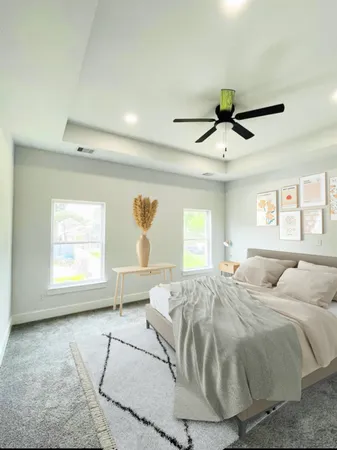 a spacious bedroom with a large bed and a window