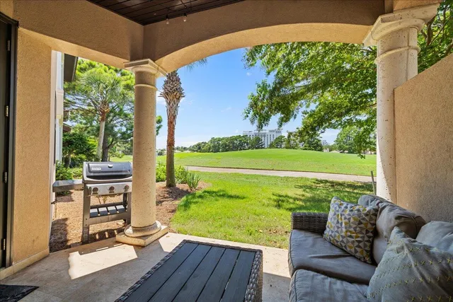 a view of a chairs and table in patio with a yard