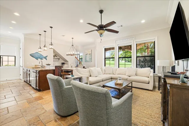 a living room with furniture tv and a large window