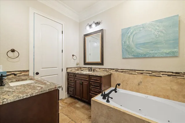 a bathroom with a tub sink and mirror
