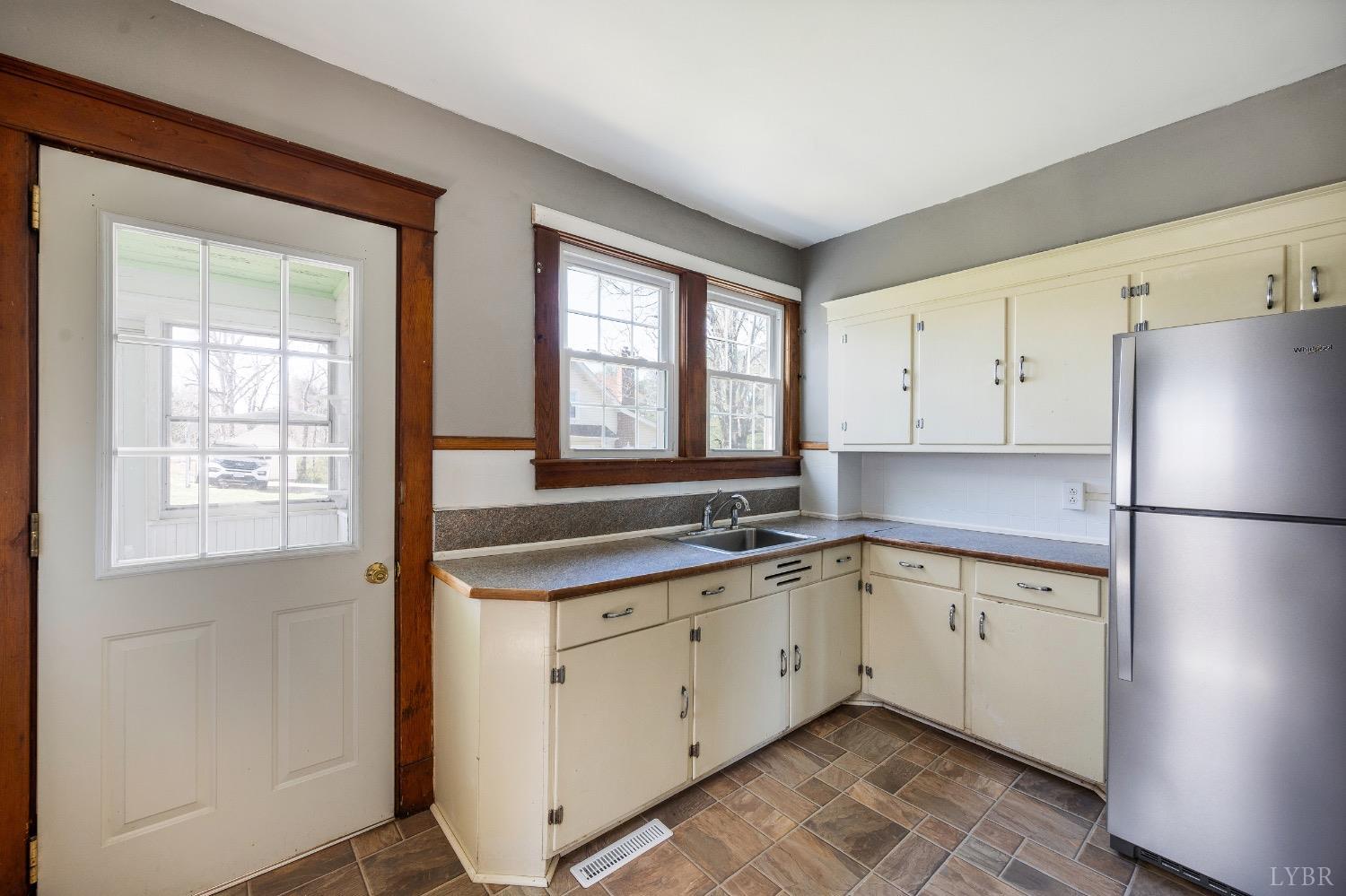 501 West Spencer Road Hurt, VA 24563 - Photo 16 of 55 a kitchen with a sink a refrigerator and window