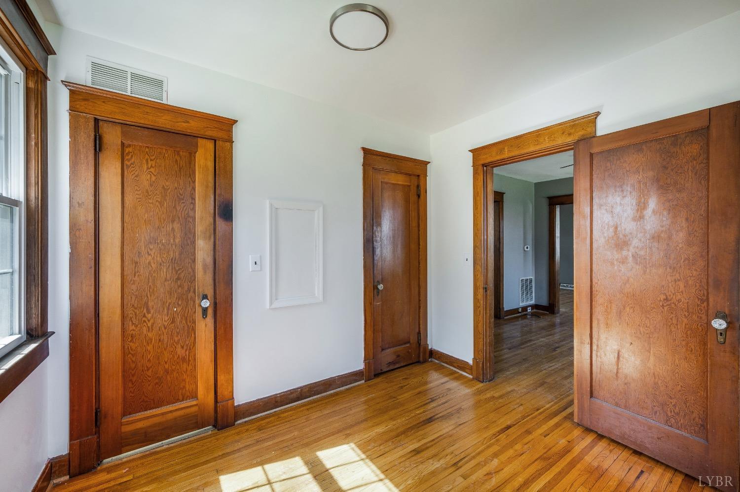 501 West Spencer Road Hurt, VA 24563 - Photo 21 of 55 an empty room with wooden floor and closet