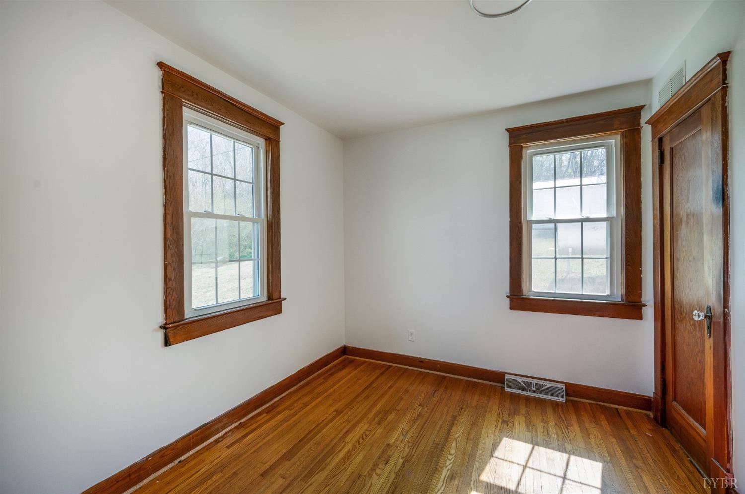 501 West Spencer Road Hurt, VA 24563 - Photo 25 of 55 a view of an empty room with wooden floor and a window