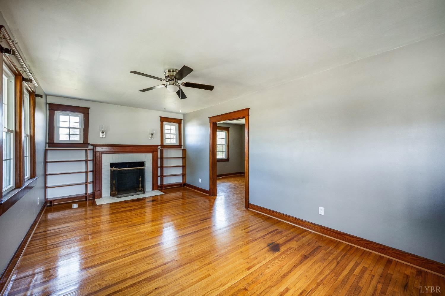 501 West Spencer Road Hurt, VA 24563 - Photo 7 of 55 wooden floor in an empty room with a fireplace