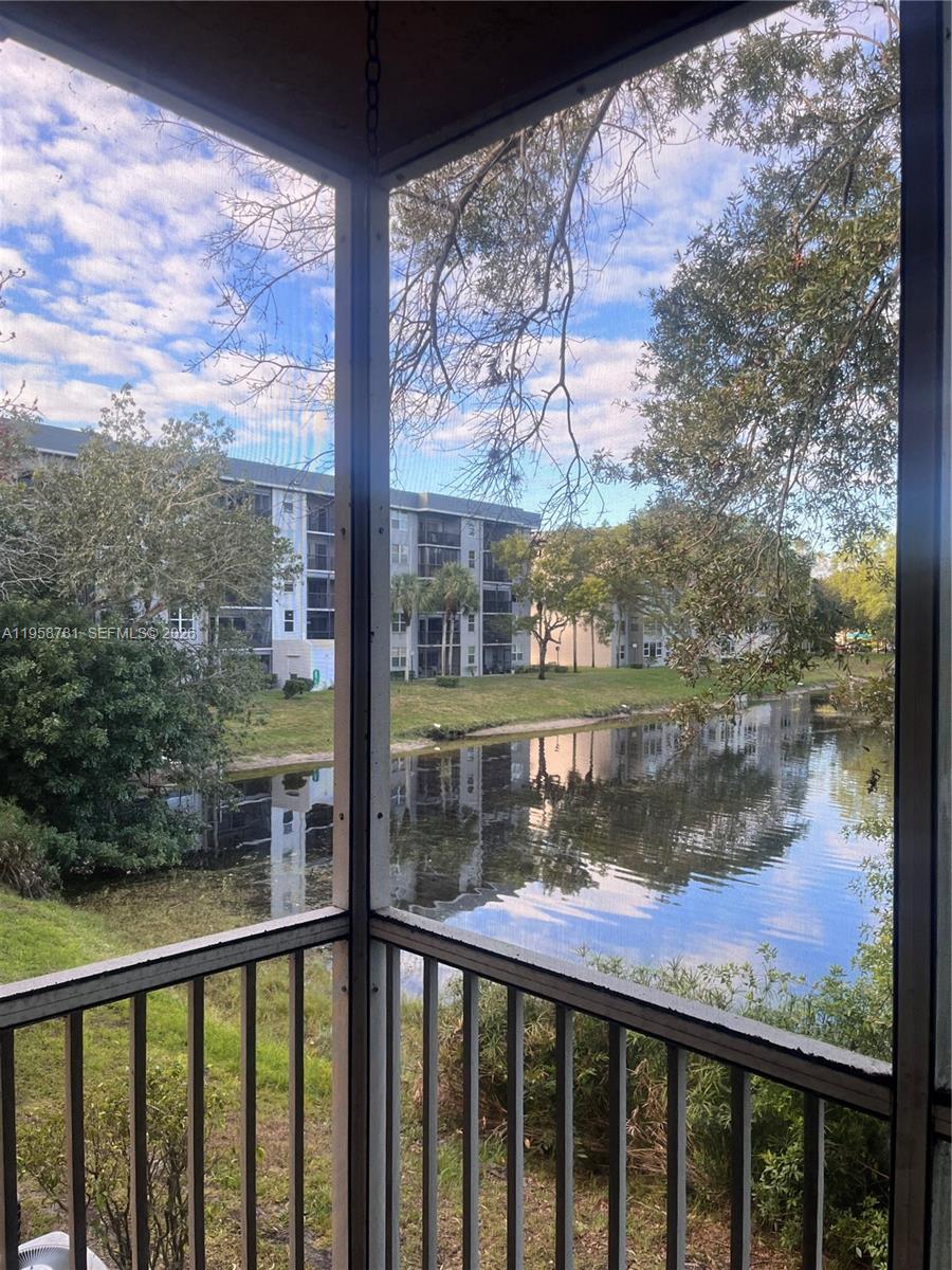 4055 West McNab Road, Unit H211 Pompano Beach, FL 33069 - Photo 15 of 22 a view of a lake from a balcony