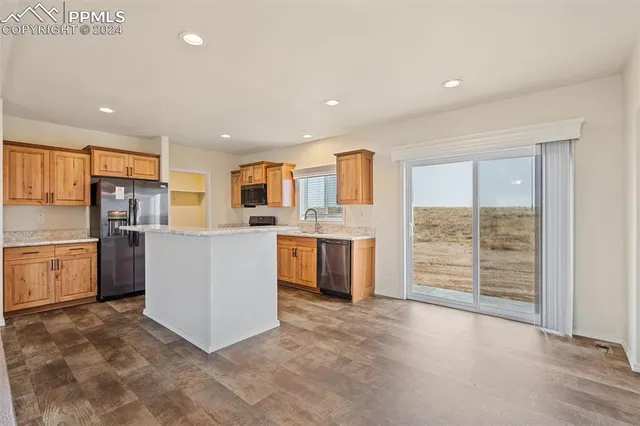 a large kitchen with cabinets and stainless steel appliances