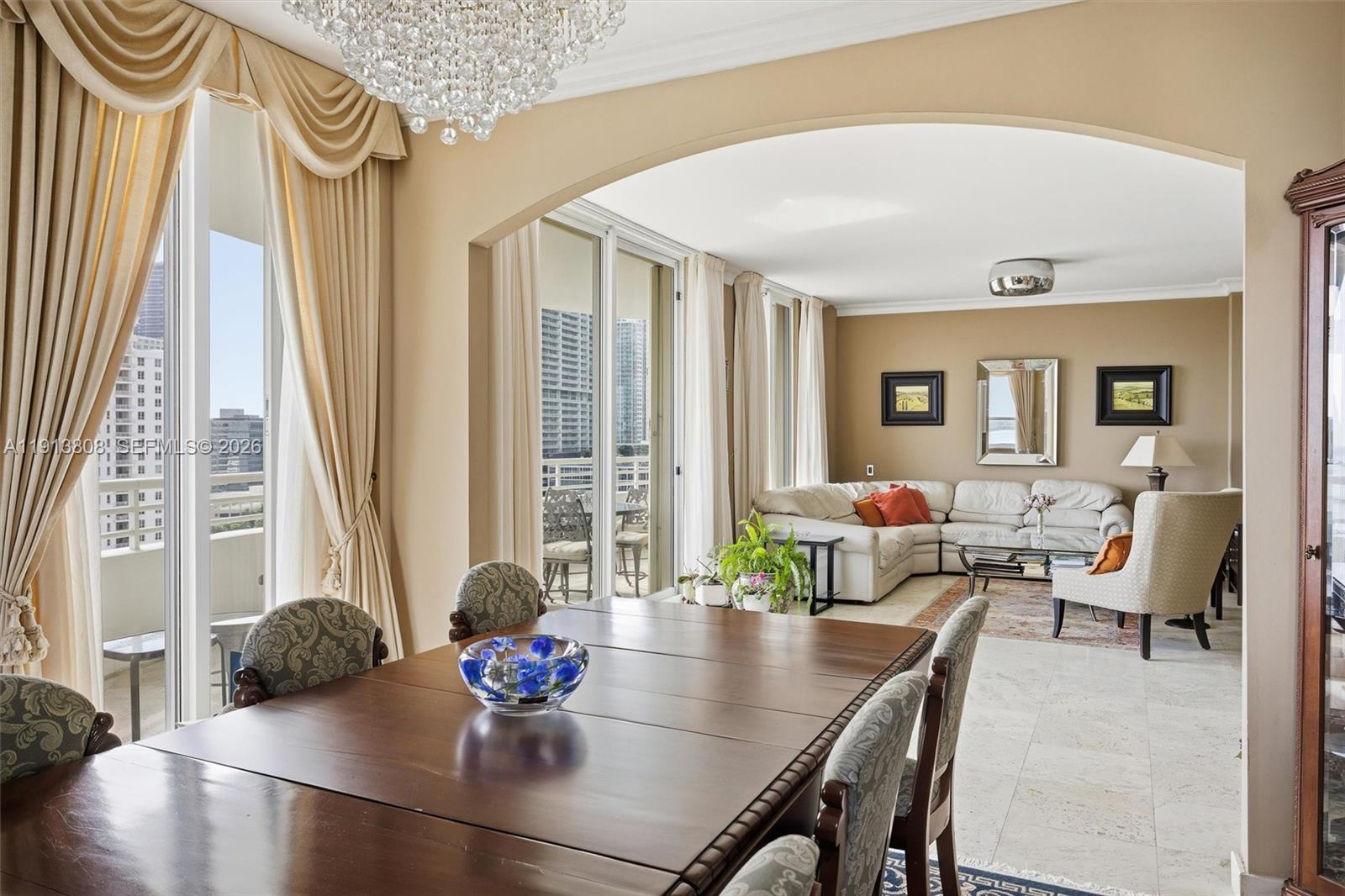 888 Brickell Key Drive, Unit 1903 Miami, FL 33131 - Photo 12 of 38 a living room with furniture and a large window