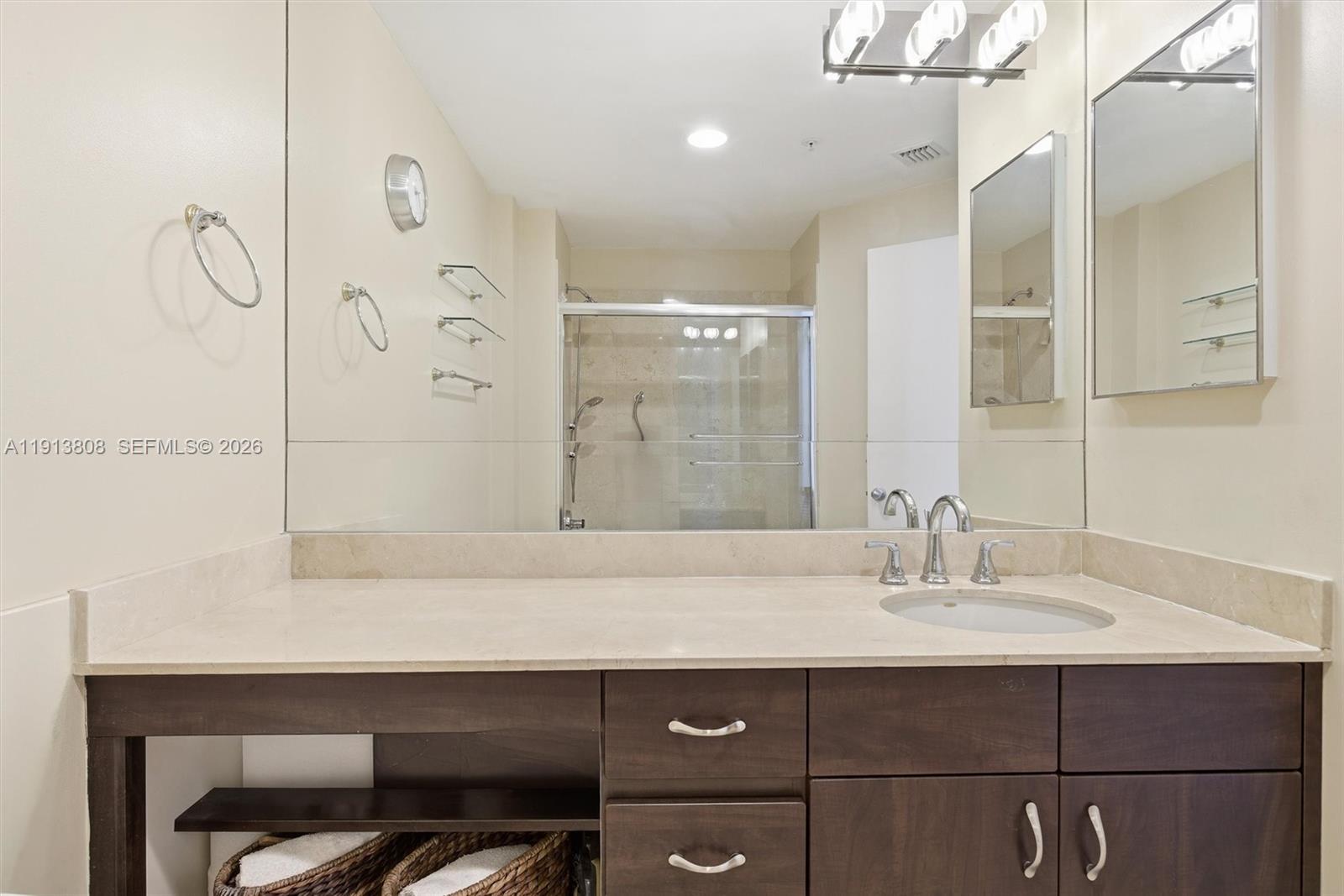 888 Brickell Key Drive, Unit 1903 Miami, FL 33131 - Photo 18 of 38 a bathroom with a sink vanity and a mirror