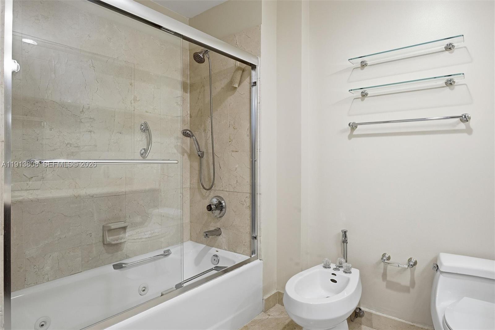 888 Brickell Key Drive, Unit 1903 Miami, FL 33131 - Photo 19 of 38 a bathroom with a toilet and a bathtub