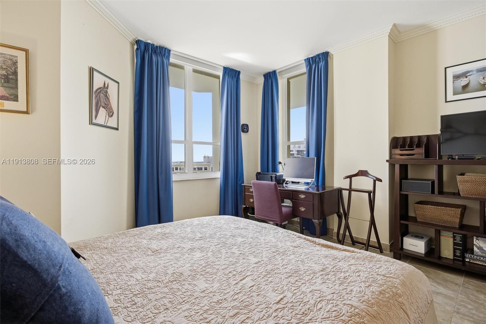 888 Brickell Key Drive, Unit 1903 Miami, FL 33131 - Photo 23 of 38 a bedroom with a bed and a television