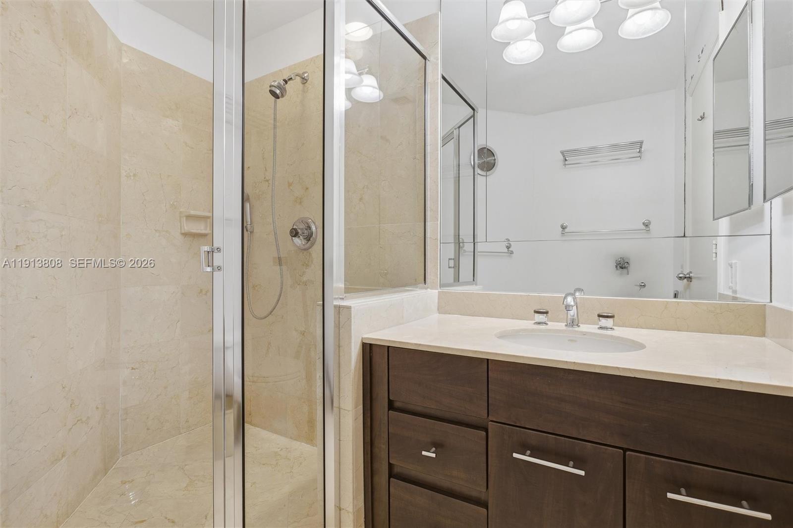 888 Brickell Key Drive, Unit 1903 Miami, FL 33131 - Photo 24 of 38 a bathroom with a sink shower and a mirror