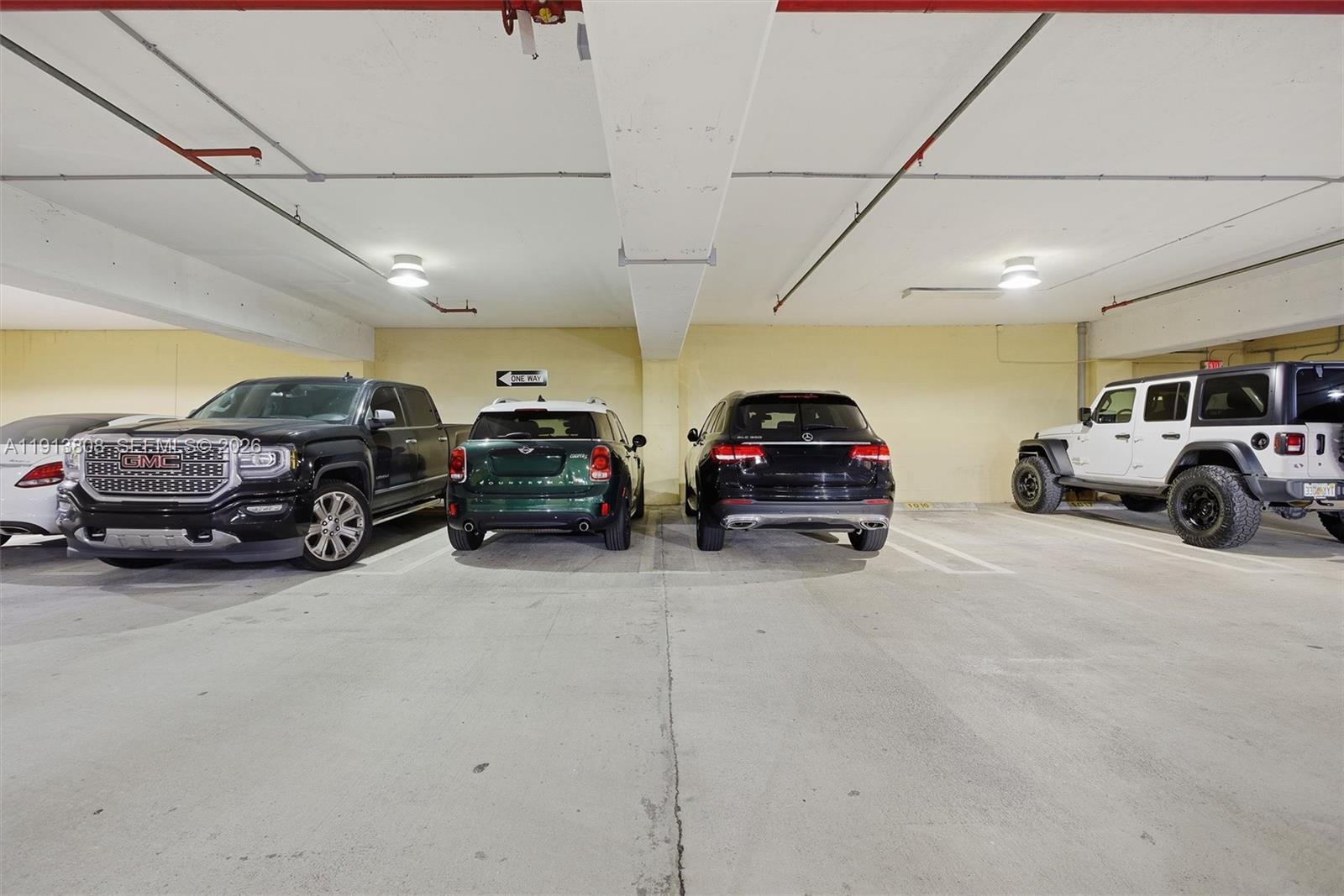 888 Brickell Key Drive, Unit 1903 Miami, FL 33131 - Photo 27 of 38 a view of cars parked in a parking