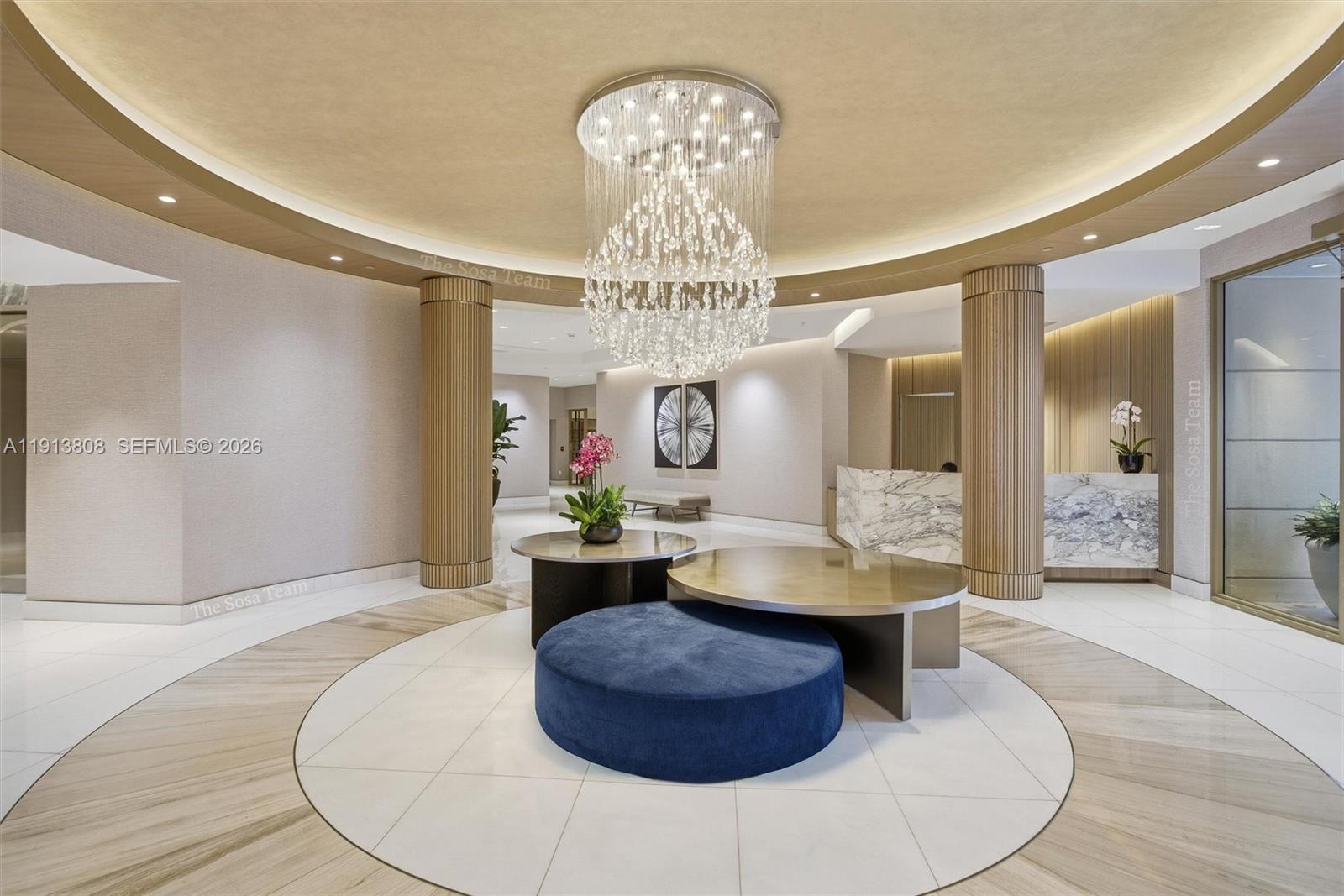 888 Brickell Key Drive, Unit 1903 Miami, FL 33131 - Photo 5 of 38 a living room with furniture and a chandelier