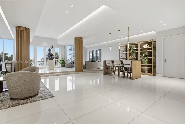 a living room with furniture and large windows