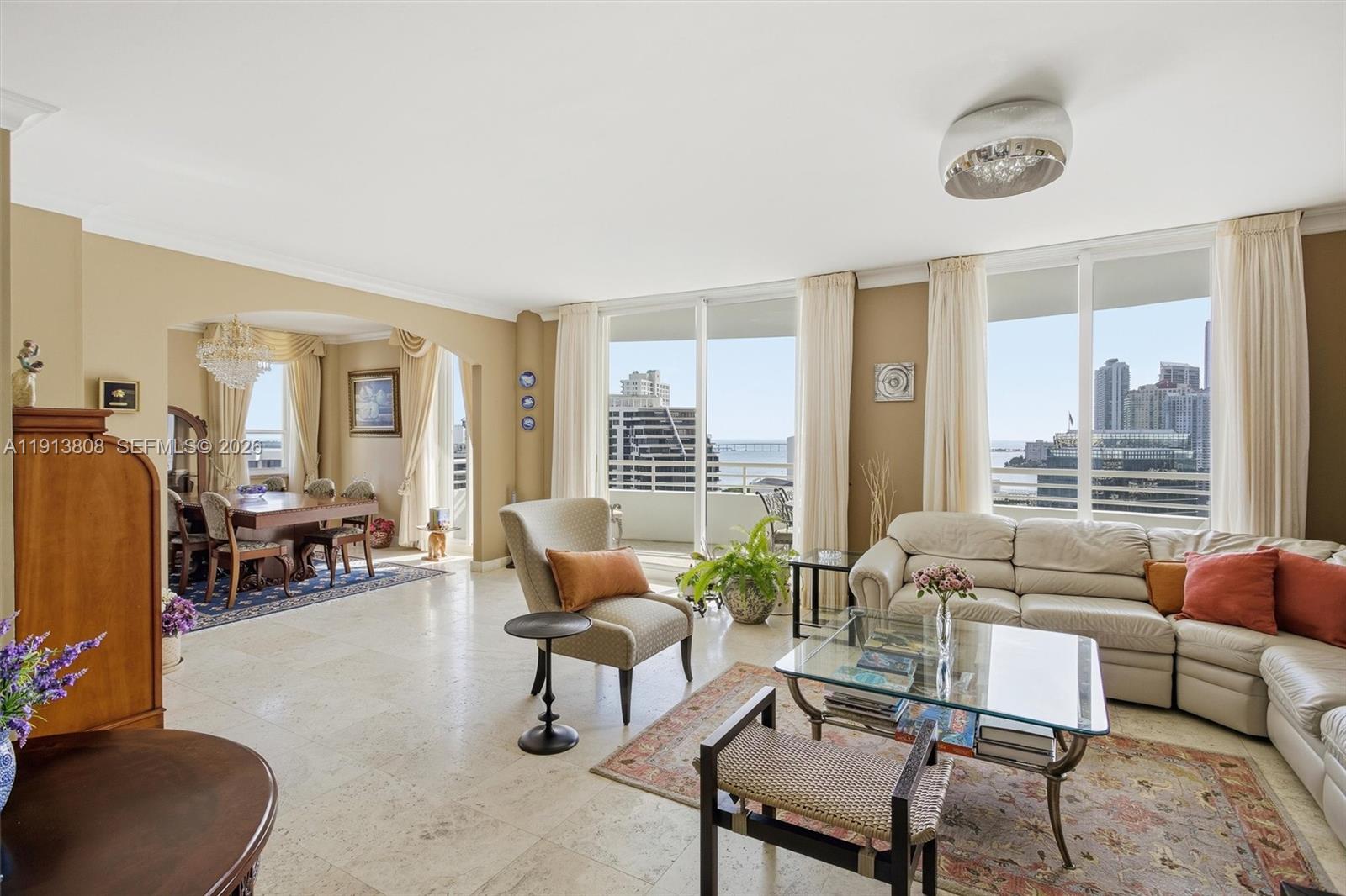 888 Brickell Key Drive, Unit 1903 Miami, FL 33131 - Photo 10 of 38 a living room with furniture and a large window