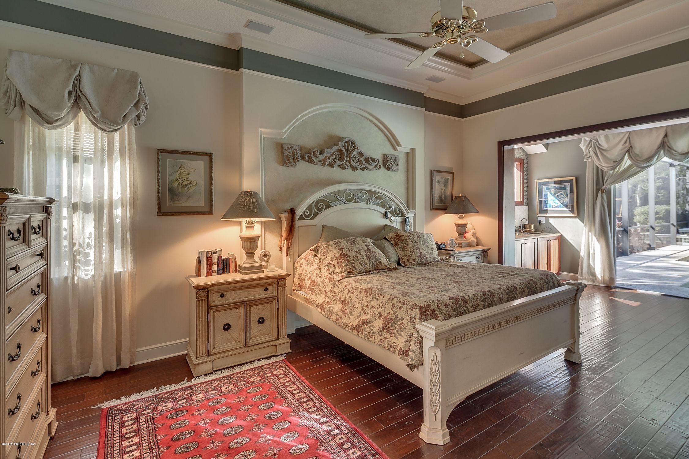 137 Pinehurst Pointe Drive St. Augustine, FL 32092 - Photo 16 of 48 a bed room with a bed and a chandelier