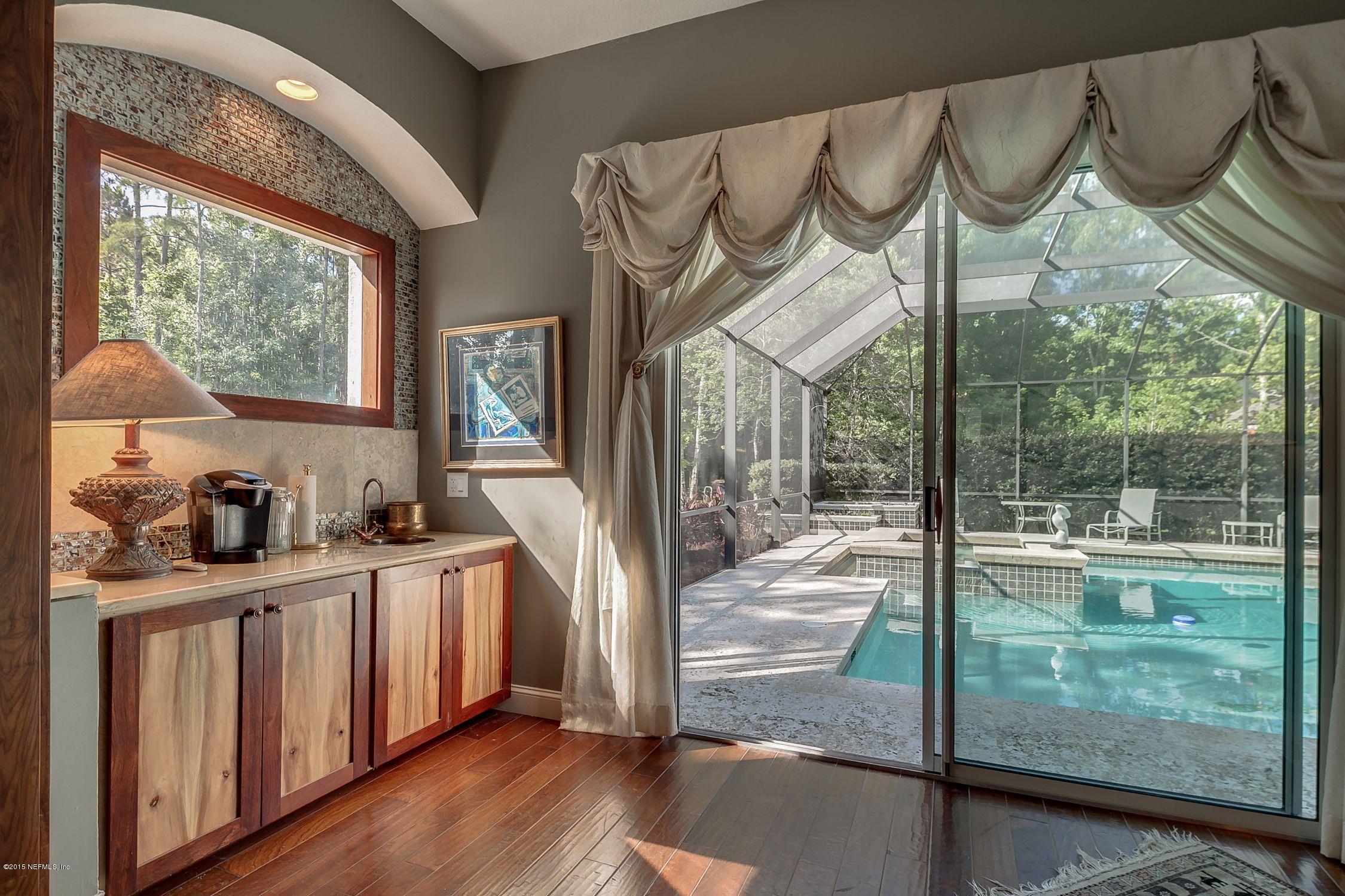 137 Pinehurst Pointe Drive St. Augustine, FL 32092 - Photo 19 of 48 a open kitchen with white cabinets and wooden floor