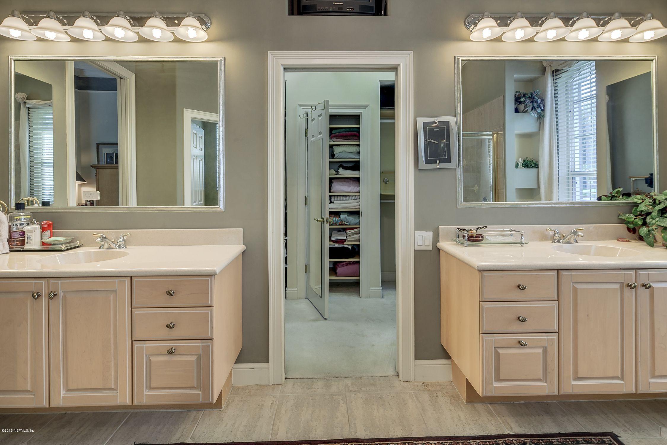 137 Pinehurst Pointe Drive St. Augustine, FL 32092 - Photo 21 of 48 a bathroom with a double vanity sink and a mirror