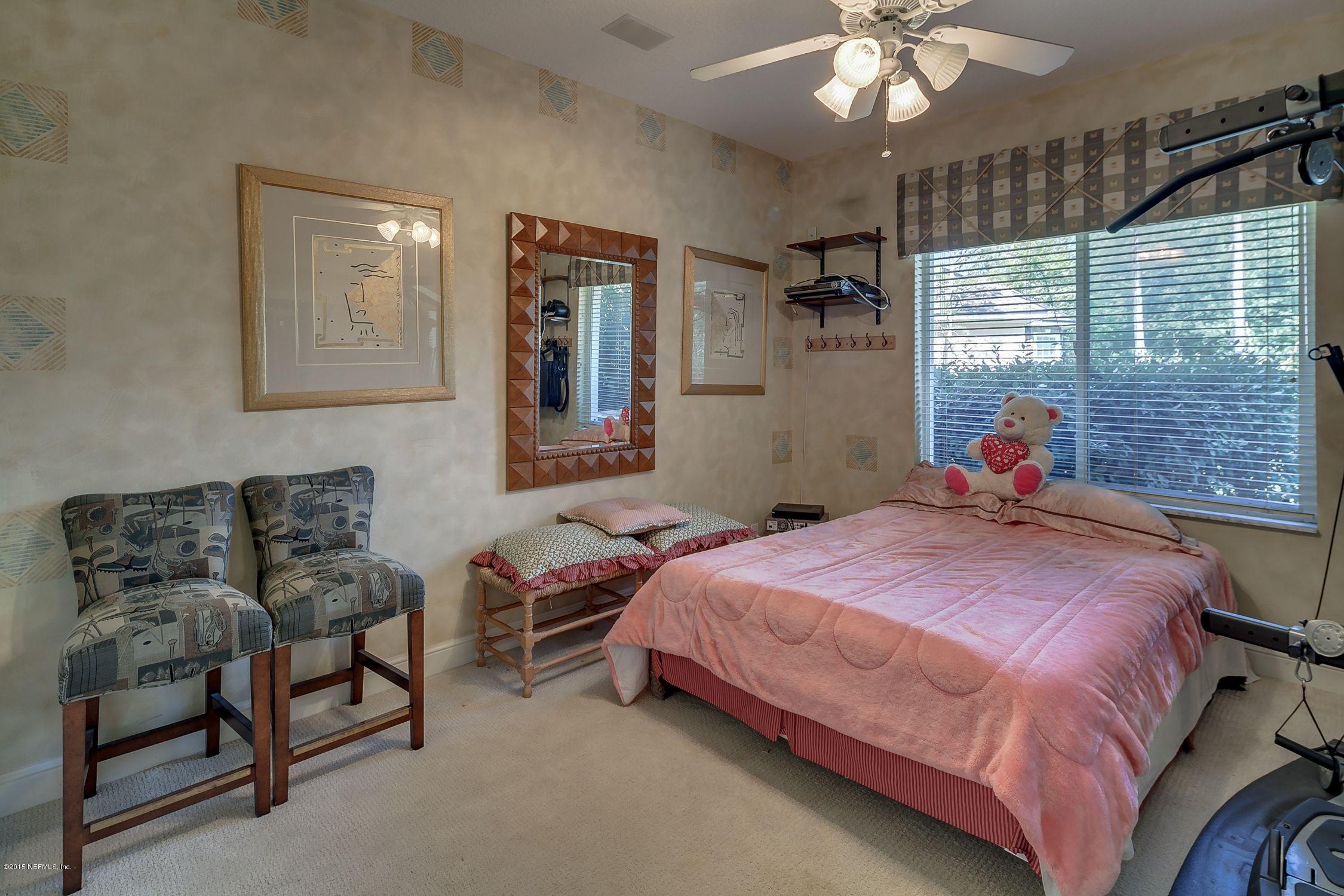 137 Pinehurst Pointe Drive St. Augustine, FL 32092 - Photo 23 of 48 a bedroom with a bed and a chandelier