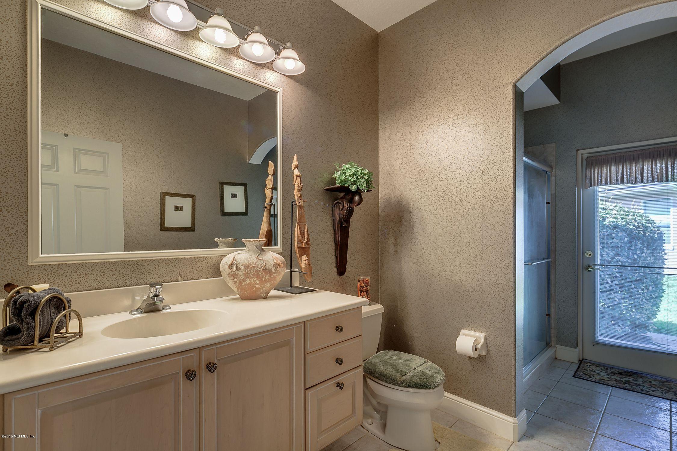 137 Pinehurst Pointe Drive St. Augustine, FL 32092 - Photo 25 of 48 a bathroom with a toilet a sink and mirror