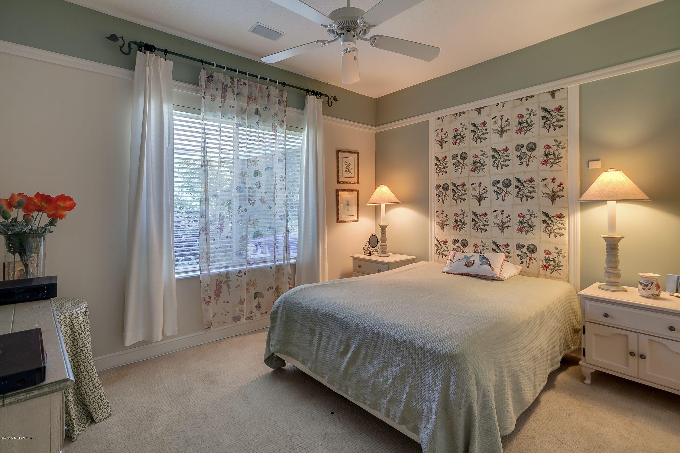137 Pinehurst Pointe Drive St. Augustine, FL 32092 - Photo 27 of 48 a bedroom with a bed and a window