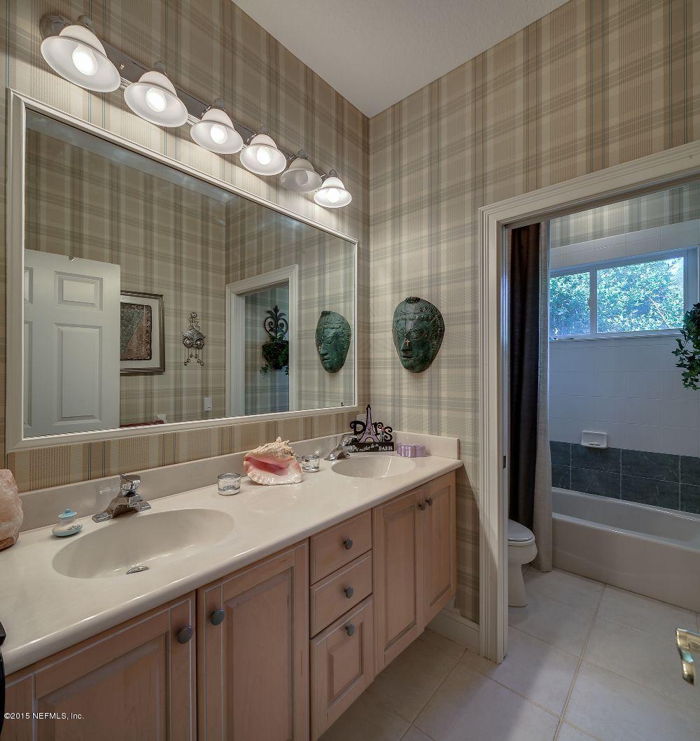 137 Pinehurst Pointe Drive St. Augustine, FL 32092 - Photo 29 of 48 a bathroom with a double vanity sink and a mirror