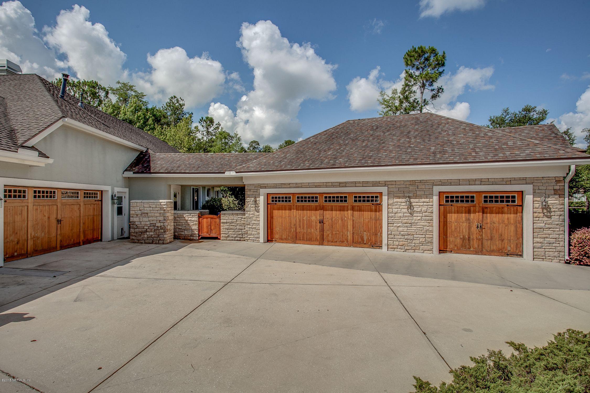 137 Pinehurst Pointe Drive St. Augustine, FL 32092 - Photo 36 of 48 a front view of a house with a yard and garage