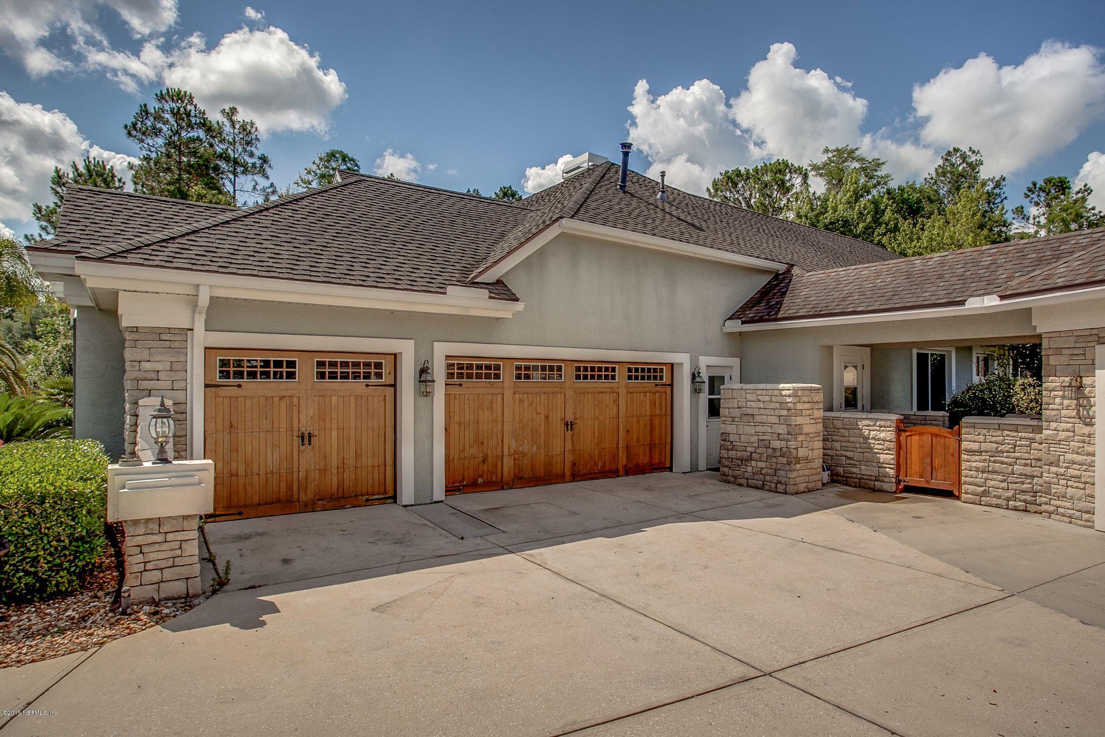 137 Pinehurst Pointe Drive St. Augustine, FL 32092 - Photo 38 of 48 a front view of a house with a yard and garage