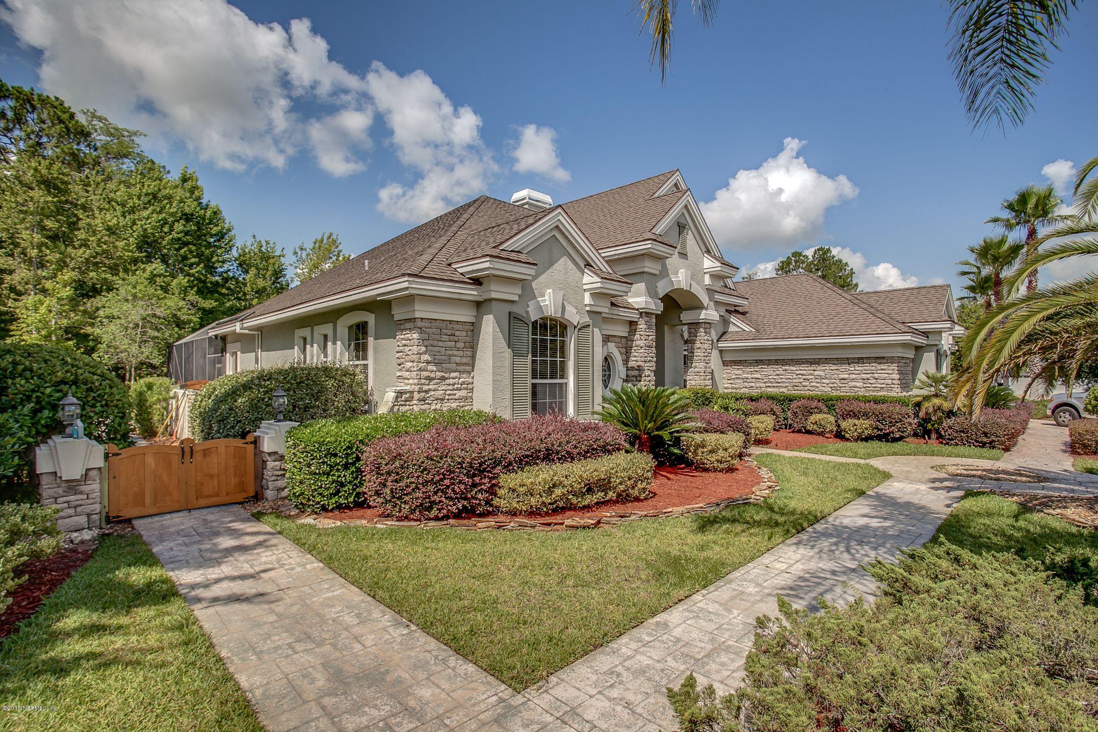 137 Pinehurst Pointe Drive St. Augustine, FL 32092 - Photo 39 of 48 a front view of a house with a garden and outdoor seating