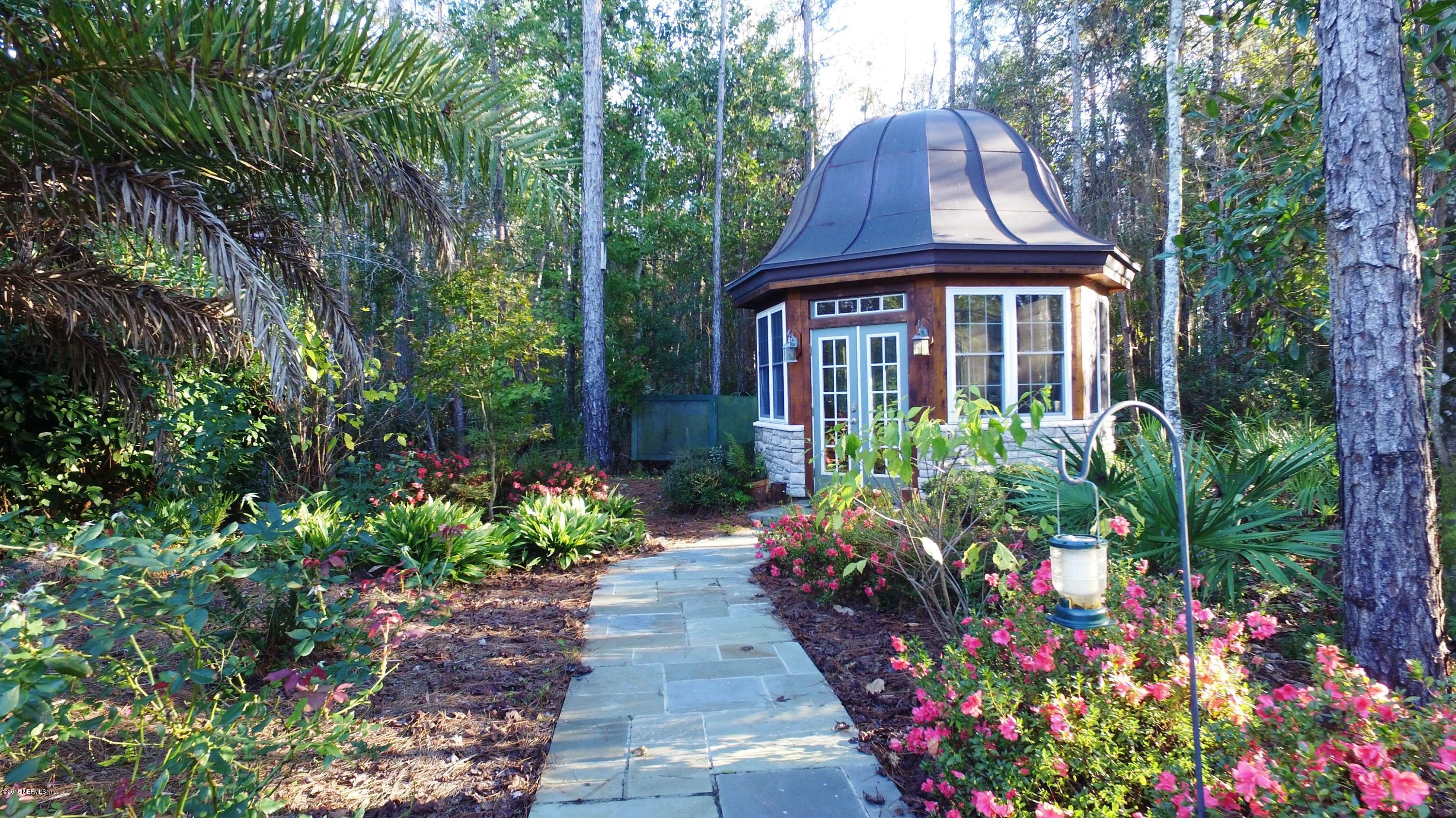 137 Pinehurst Pointe Drive St. Augustine, FL 32092 - Photo 46 of 48 a front view of a house with a yard and fountain in middle