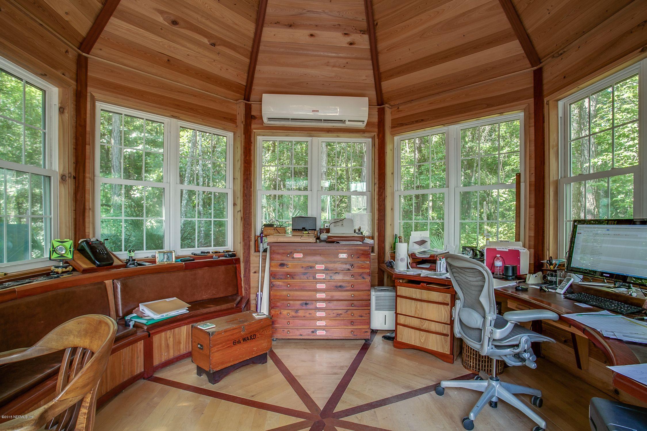 137 Pinehurst Pointe Drive St. Augustine, FL 32092 - Photo 47 of 48 a living room with furniture and floor to ceiling windows