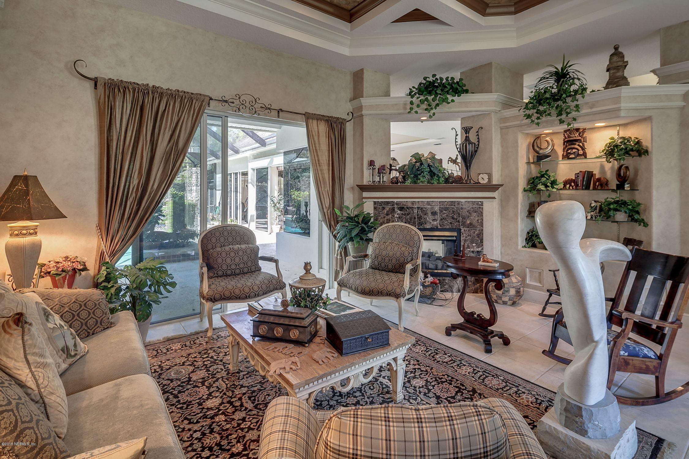 137 Pinehurst Pointe Drive St. Augustine, FL 32092 - Photo 6 of 48 a living room with furniture a rug and a floor to ceiling window
