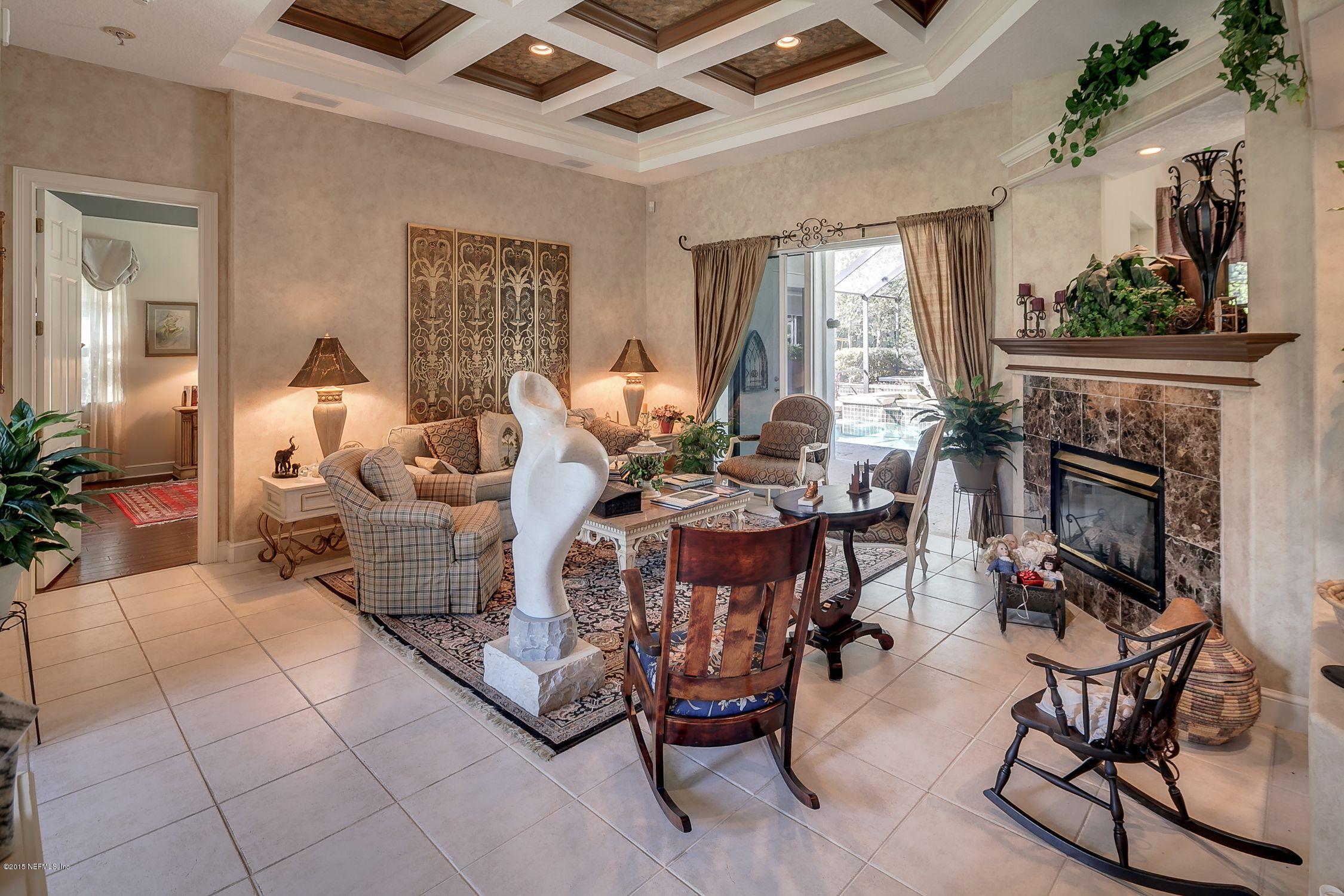 137 Pinehurst Pointe Drive St. Augustine, FL 32092 - Photo 7 of 48 a living room with furniture and a fireplace