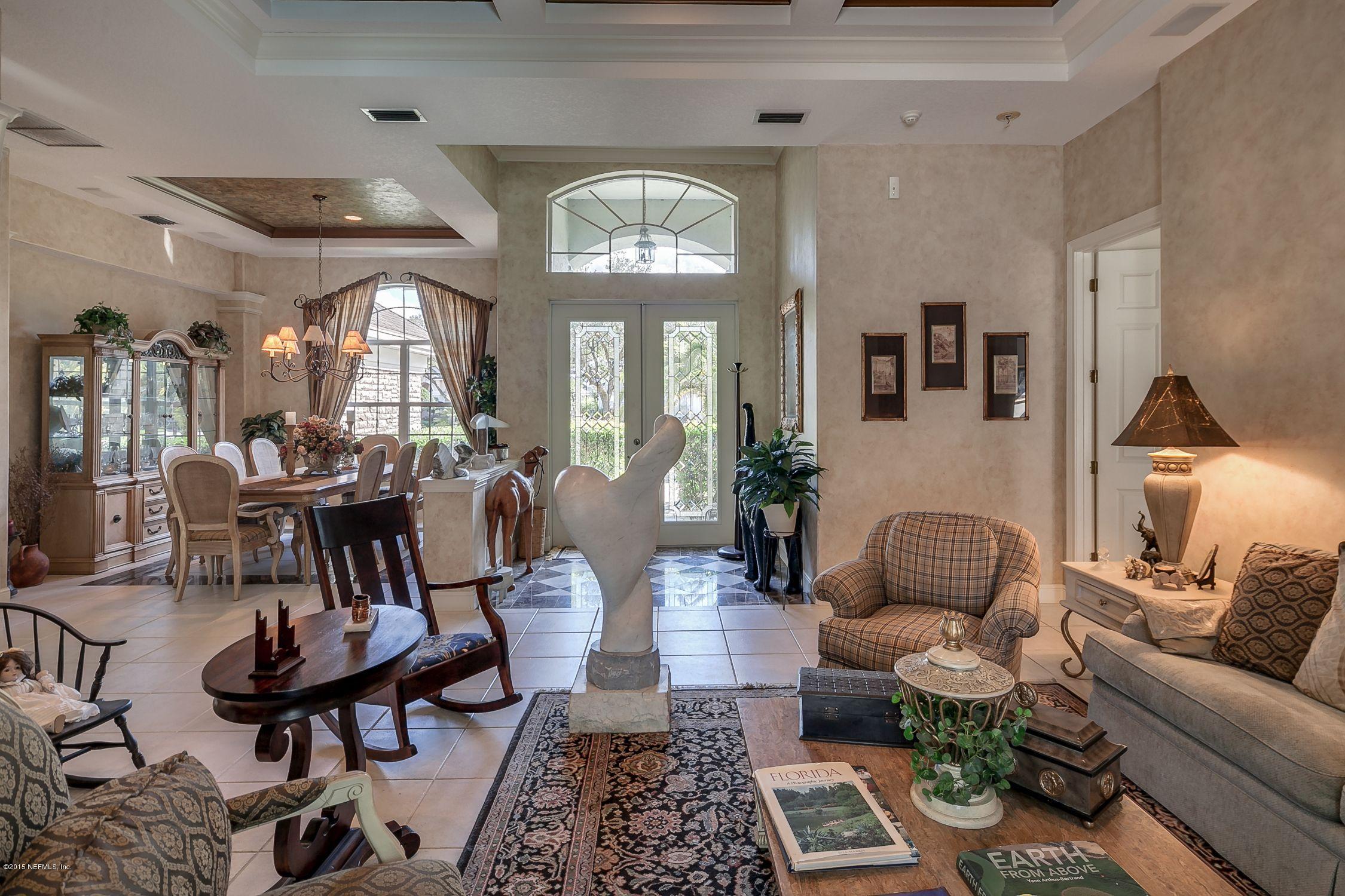 137 Pinehurst Pointe Drive St. Augustine, FL 32092 - Photo 8 of 48 a living room with furniture a chandelier and a dining table