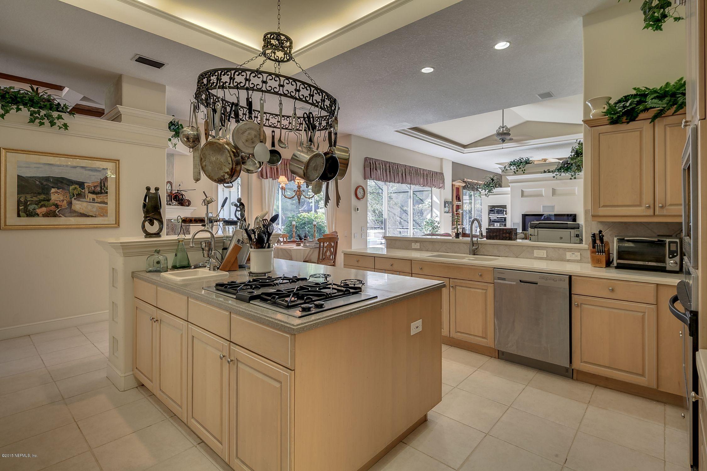 137 Pinehurst Pointe Drive St. Augustine, FL 32092 - Photo 10 of 48 a kitchen with stainless steel appliances granite countertop a stove a sink and a refrigerator