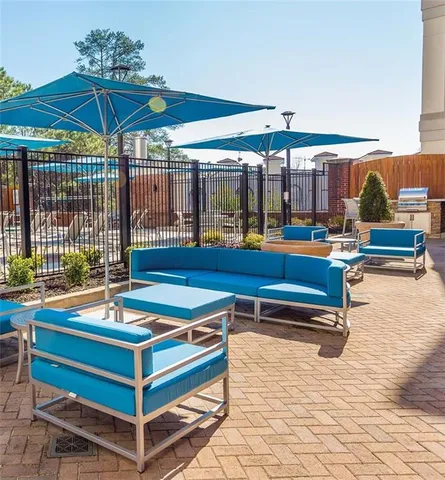 a outdoor space with pool table and chairs