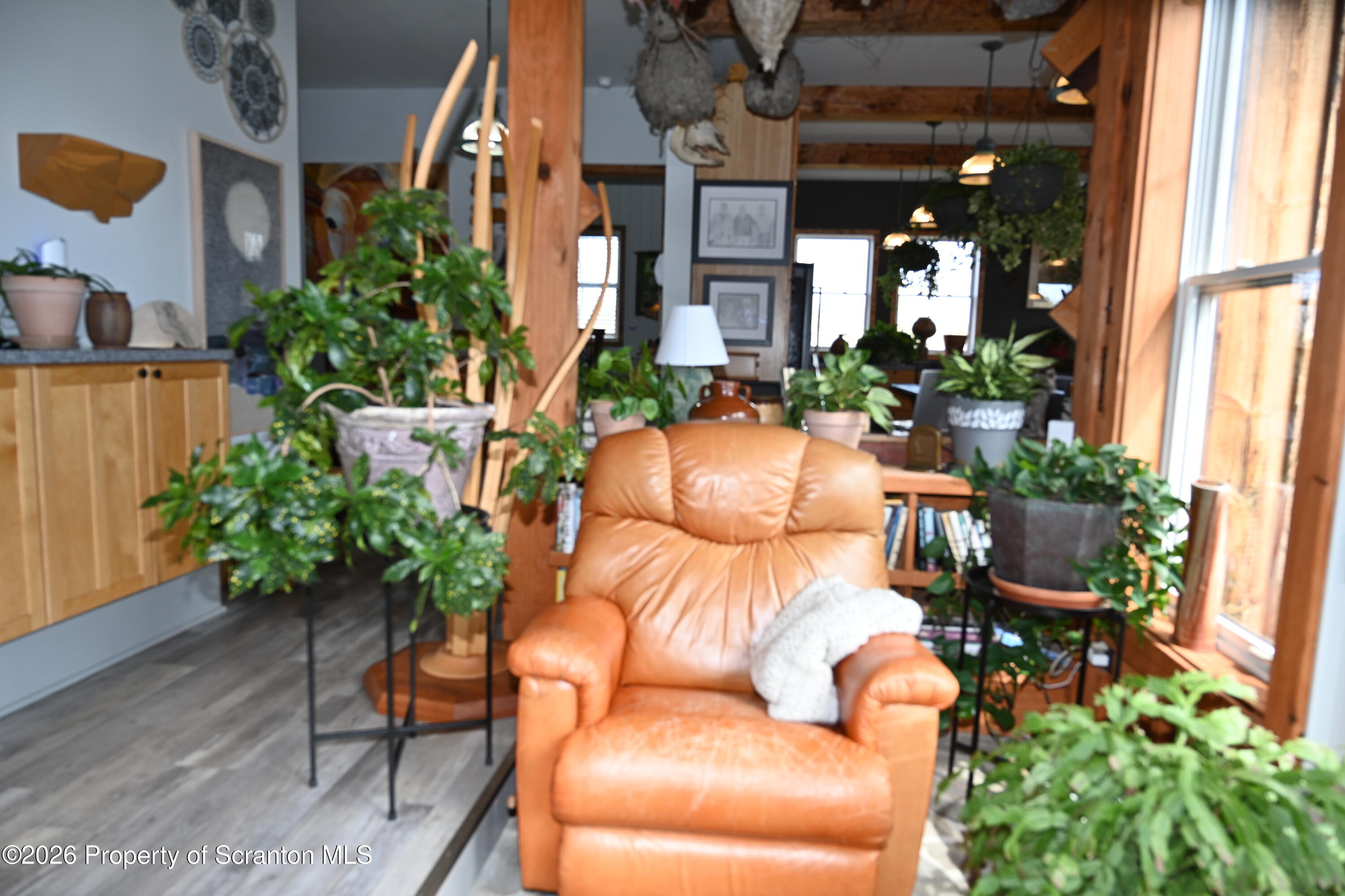 512-318 Johnson Pond Road Montrose, PA 18801 - Photo 28 of 89 a view of a patio with table and chairs potted plants and floor to ceiling window