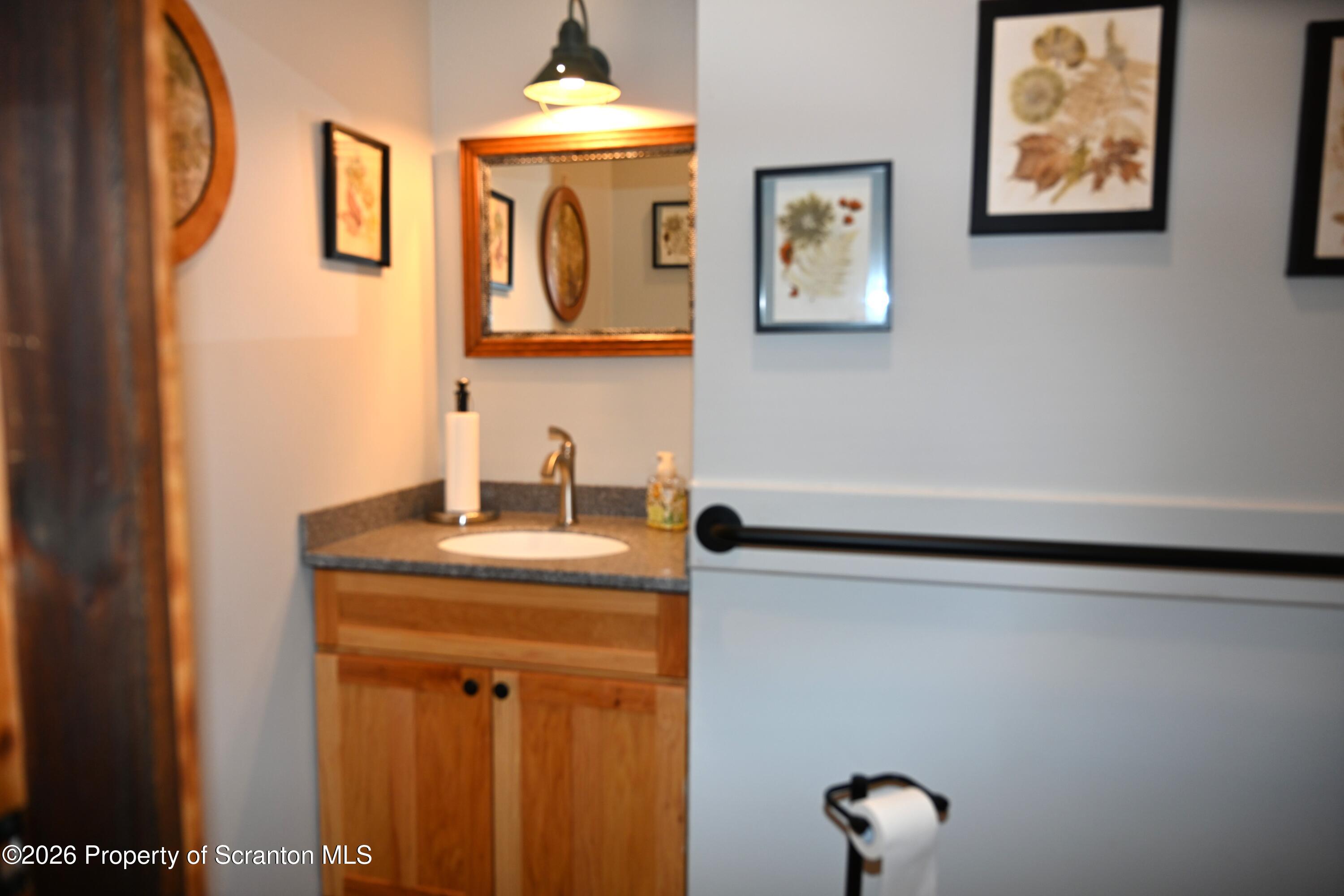 512-318 Johnson Pond Road Montrose, PA 18801 - Photo 40 of 89 a bathroom with a sink and a mirror