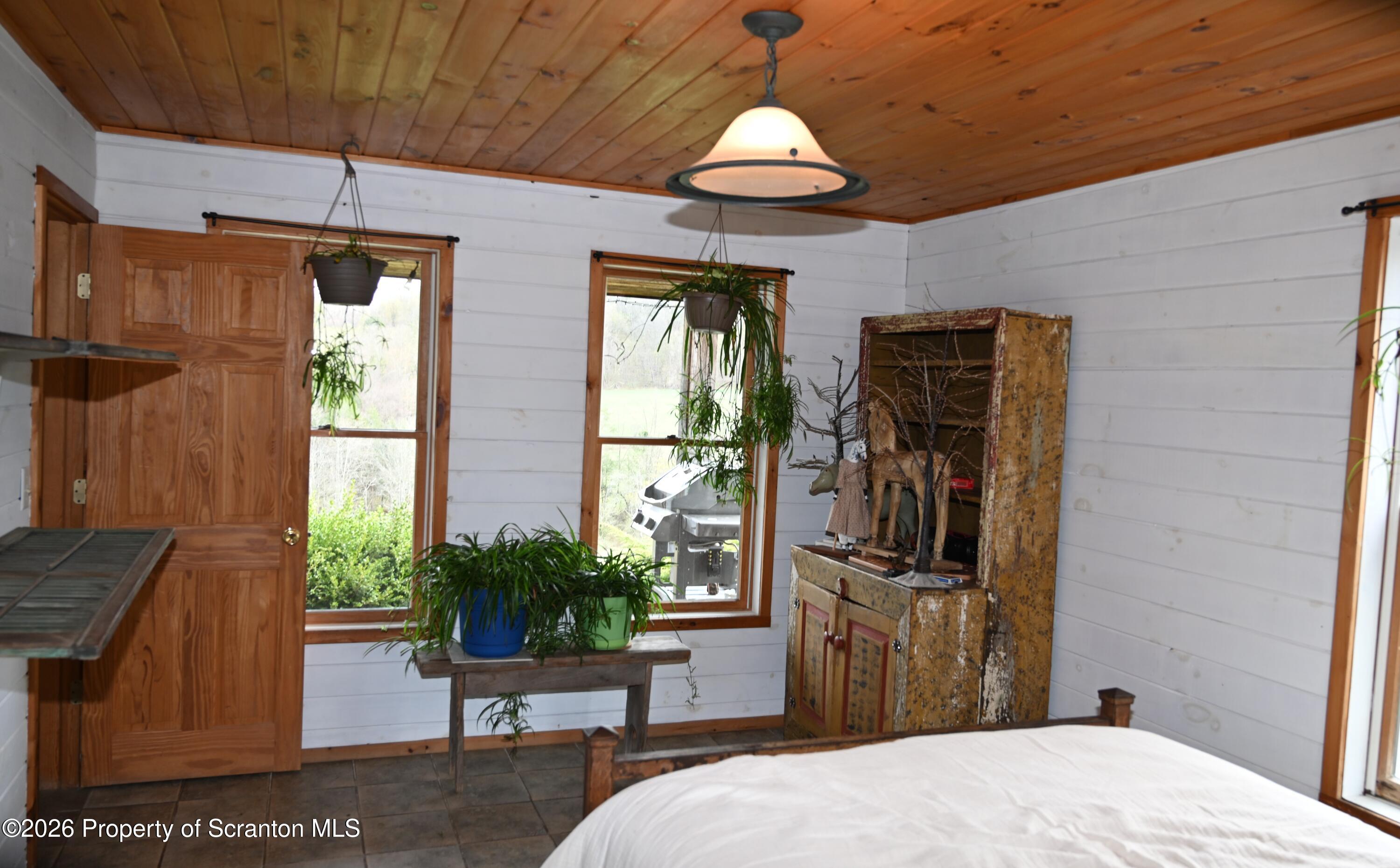 512-318 Johnson Pond Road Montrose, PA 18801 - Photo 70 of 89 a bedroom with a bed and wooden floor